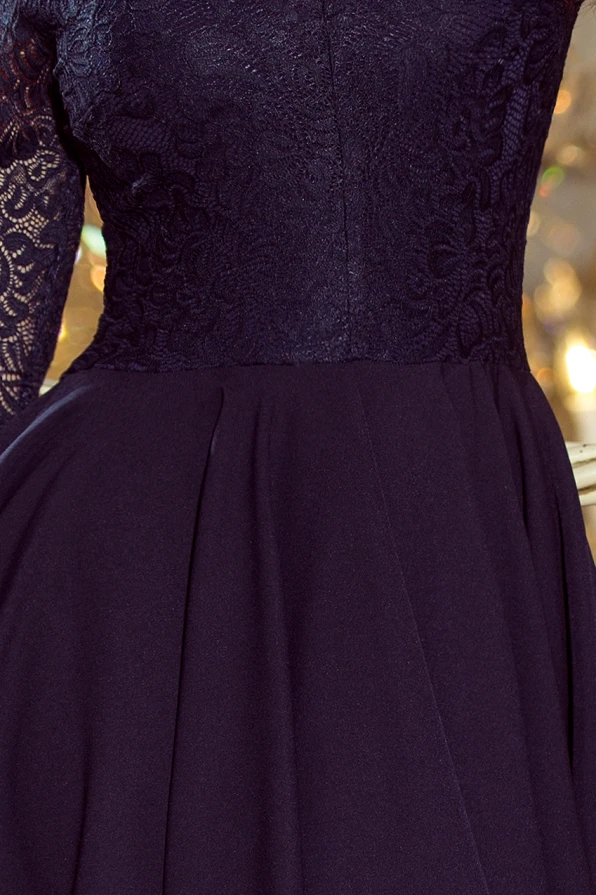 A navy blue dress featuring a fitted lace bodice with long sleeves and a flowing, pleated skirt. The elegant design is perfect for formal occasions, offering a sophisticated and timeless look.