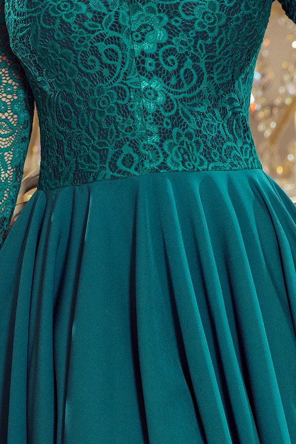 The image showcases an elegant dress featuring a fitted lace bodice with intricate floral patterns and long sleeves. The skirt is made of a smooth, flowing fabric that adds a touch of sophistication to the overall design.
