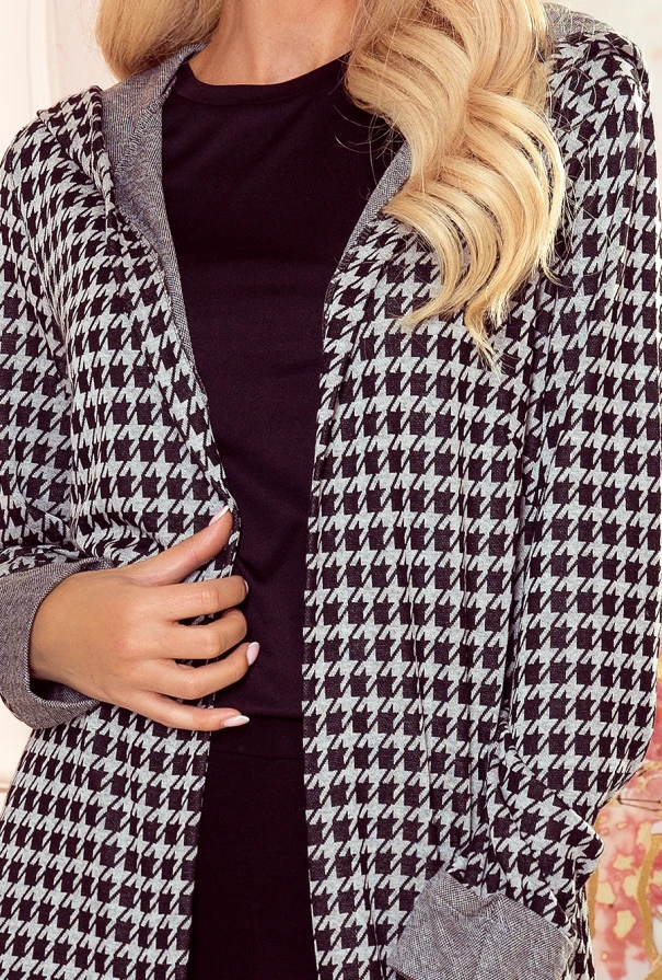 A warm, stylish houndstooth-patterned cardigan with a hood, perfect for layering in cooler weather. The cardigan features a classic black and white design, adding a chic touch to any outfit.