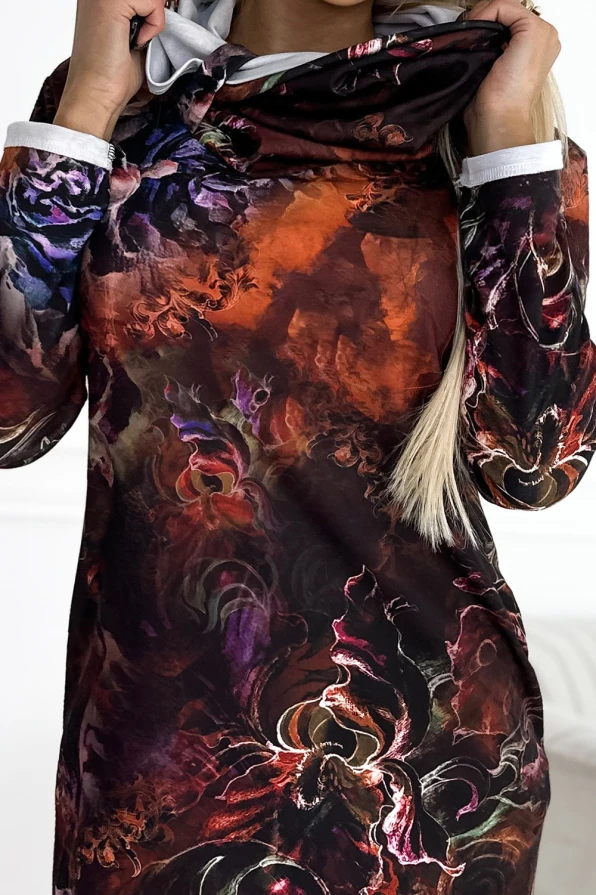 A warm, long-sleeved dress featuring a vibrant, abstract floral pattern in rich autumnal colors. The dress has a cozy hood and a soft, comfortable fabric, perfect for cooler weather.
