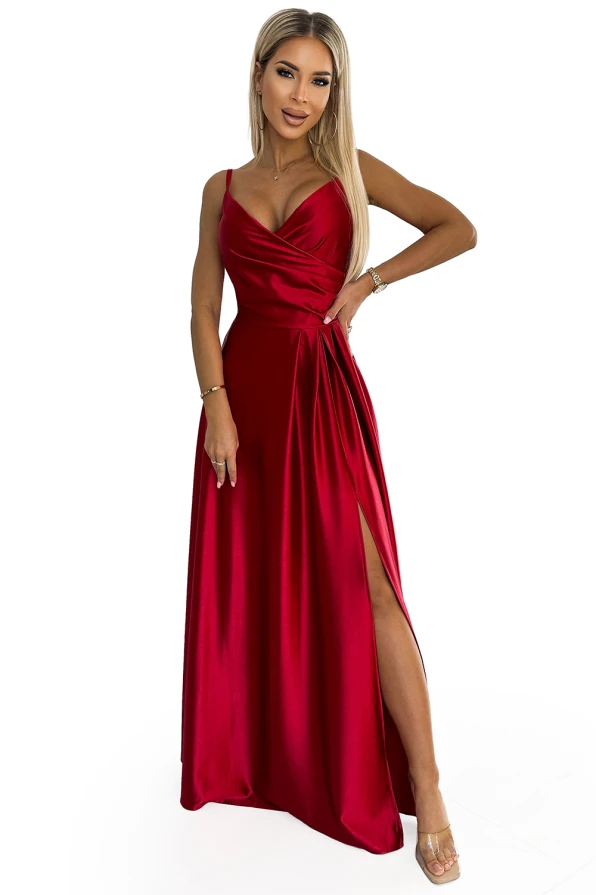 A stunning red maxi dress with a silky finish, featuring a draped neckline and a high slit for an elegant look. The dress is sleeveless with thin straps, perfect for formal occasions.