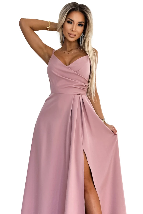 A long, elegant pink maxi dress with a wrap-style bodice and a high slit, perfect for formal occasions. The dress features delicate shoulder straps and a flowing skirt that adds a touch of sophistication.