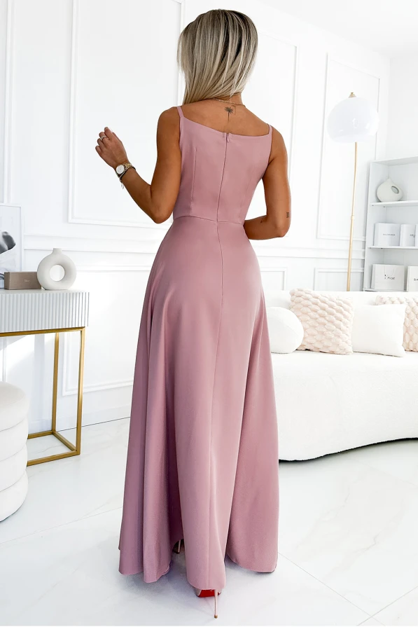 Elegant maxi dress in a soft pink hue, featuring a sleeveless design and a flowing skirt. The dress is perfect for formal occasions, offering a sophisticated and graceful silhouette.