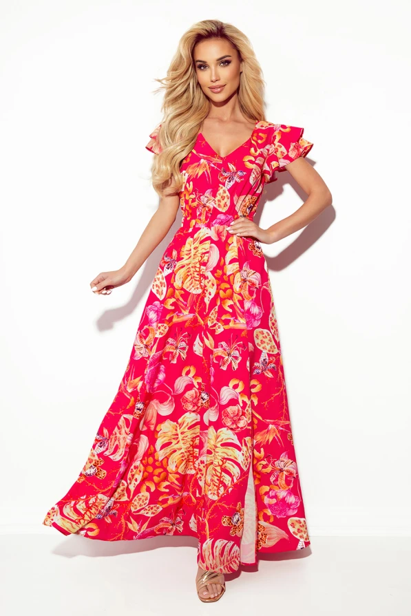A long, vibrant dress features a tropical floral pattern in shades of red, orange, and pink, with flutter sleeves adding a touch of elegance. The flowing silhouette and V-neckline create a graceful and summery look.