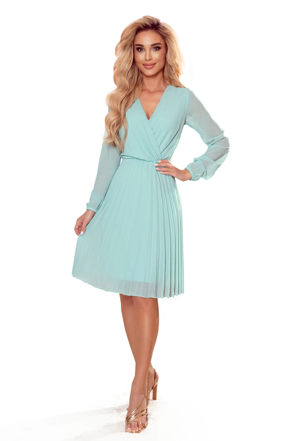 A light turquoise pleated dress with long sheer sleeves and a V-neckline, perfect for elegant occasions. The dress features a fitted waist and a flowing skirt that adds a touch of sophistication.
