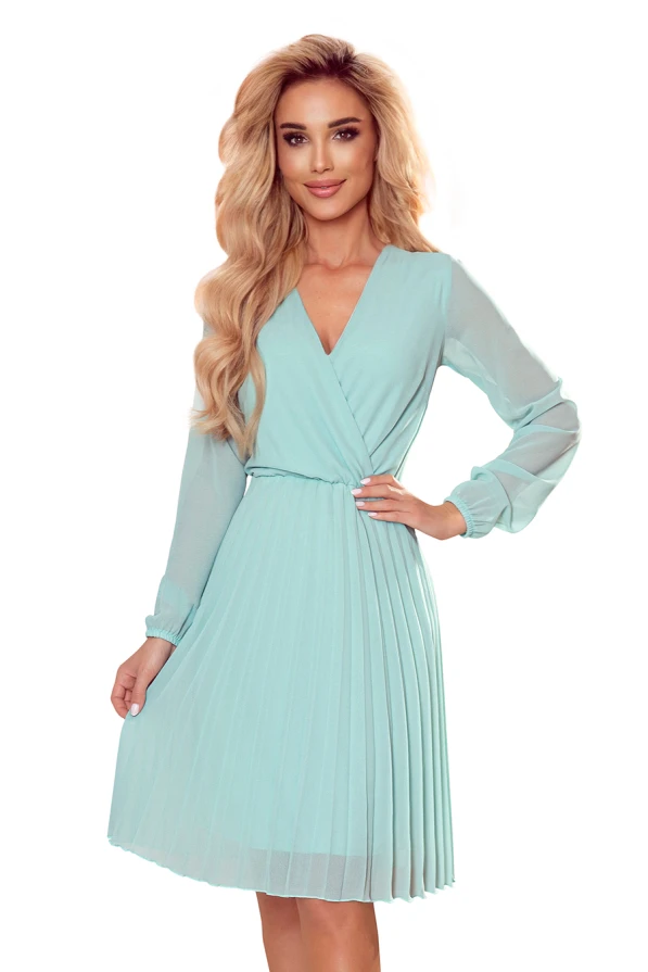 A light blue, pleated dress with long, sheer sleeves and a V-neckline, creating an elegant and flowing silhouette. The dress features a fitted waist, enhancing a graceful and feminine look.