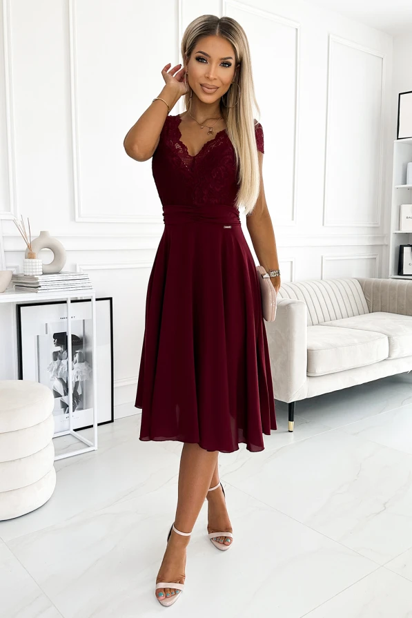 A burgundy chiffon dress with a lace bodice and short sleeves, featuring a fitted waist and a flowing knee-length skirt. The elegant design is complemented by a V-neckline and delicate detailing, perfect for formal occasions.