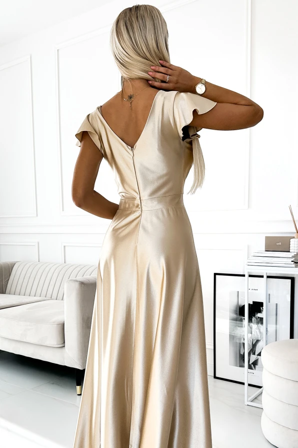 A long, satin dress in a shimmering champagne color features a deep V-back and short, flutter sleeves. The elegant design is perfect for formal occasions, offering a graceful and sophisticated look.