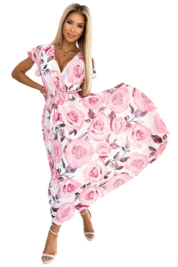 A flowing, pleated dress adorned with a vibrant pink rose pattern, featuring a wrap-style top and short sleeves. The dress is complemented by a matching belt that accentuates the waist, creating an elegant and feminine silhouette.