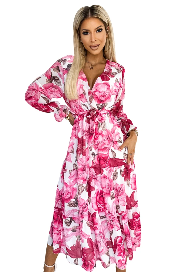 A floral midi dress with a vibrant pink and white pattern, featuring long sleeves and a cinched waist for a flattering silhouette. The lightweight fabric and flowy design make it perfect for spring and summer occasions.