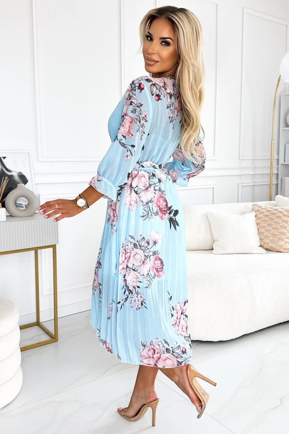 A light blue pleated dress adorned with a delicate floral pattern, featuring long sleeves and a cinched waist for an elegant silhouette. The dress exudes a soft, feminine charm, perfect for both casual and formal occasions.