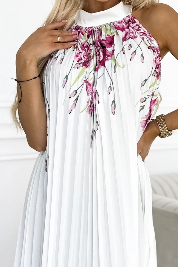 Elegant pleated satin dress in white, featuring a vibrant floral pattern with shades of pink and green. The sleeveless design and high neckline add a sophisticated touch, perfect for special occasions.