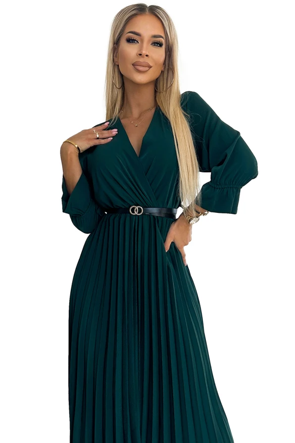A pleated, dark green dress with a V-neckline and long sleeves, cinched at the waist with a stylish belt. The elegant design is perfect for both formal and casual occasions.