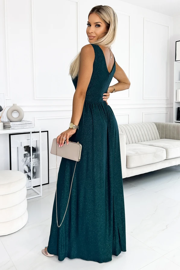 A long, elegant brocade dress in a deep teal color features a fitted bodice and a flowing skirt, perfect for formal occasions. The dress is complemented by a subtle shimmer, adding a touch of glamour to the overall look.