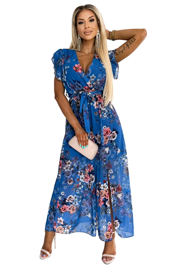 A long, elegant blue dress adorned with a vibrant floral pattern, featuring short ruffled sleeves and a matching waist tie. The flowing fabric and colorful design make it perfect for both casual and formal occasions.