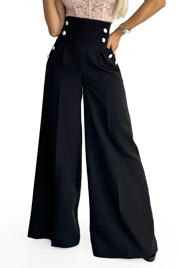 Wide-leg black trousers with a high waist feature decorative buttons on the front. The elegant design is complemented by a fitted waist and flowing fabric, creating a sophisticated silhouette.