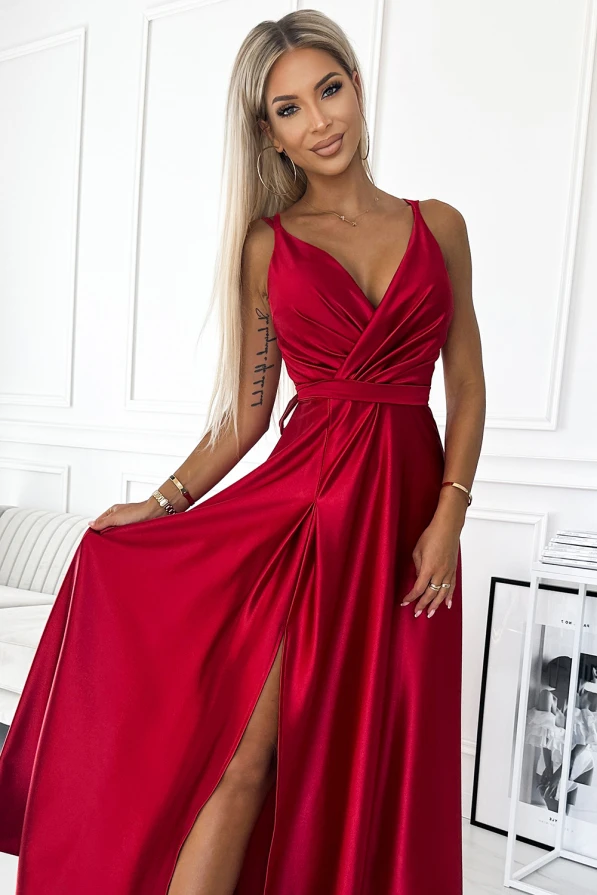 A long, satin evening gown in a vibrant red color features a deep V-neckline and a high slit, adding elegance and allure. The dress is designed with a fitted waist and flowing skirt, perfect for formal occasions.
