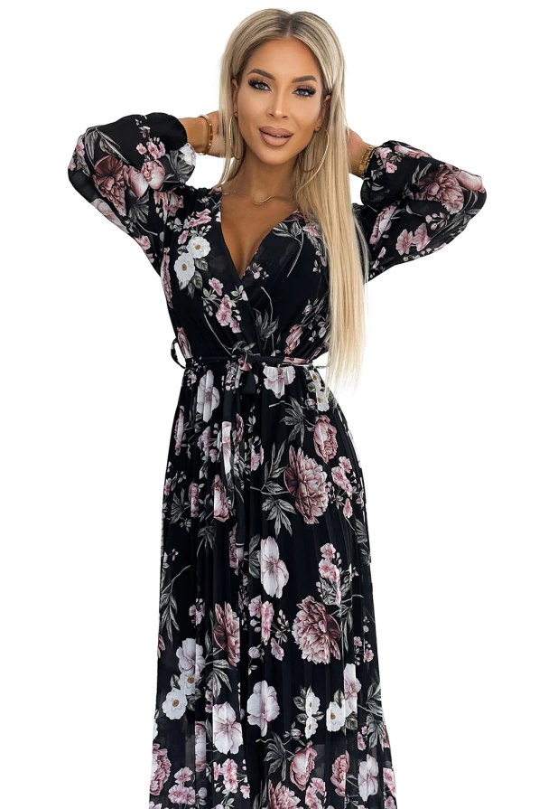 A black midi dress with a floral pattern featuring pink and white flowers, designed with long sleeves and a wrap-style V-neck. The dress includes a matching belt to accentuate the waist, creating an elegant and feminine silhouette.