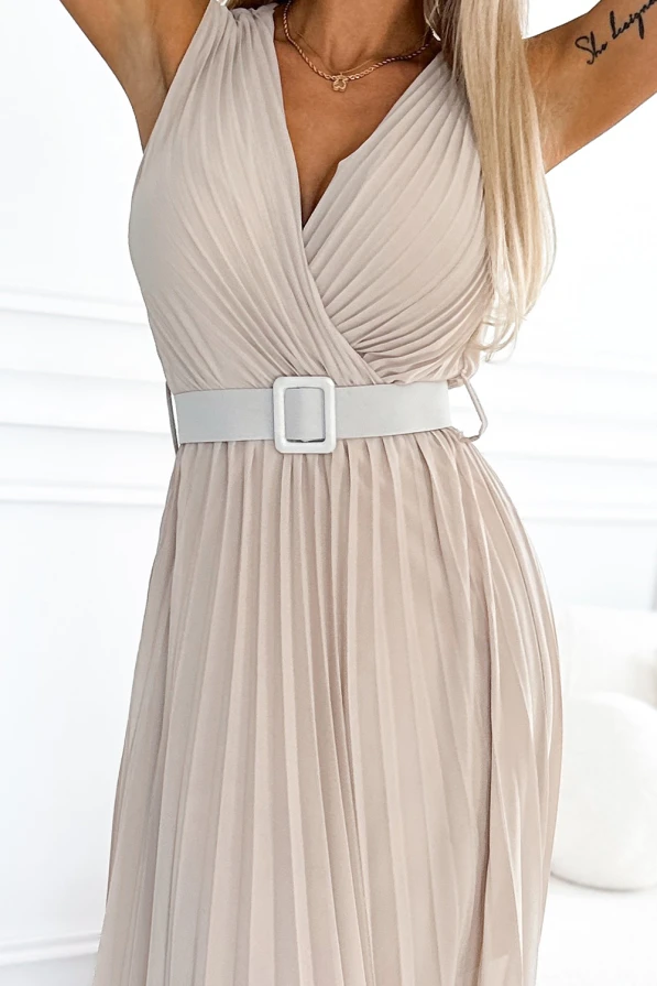 Elegant pleated dress in a soft beige color, featuring a flattering V-neckline and a stylish white belt. The lightweight fabric and flowing design make it perfect for both casual and formal occasions.