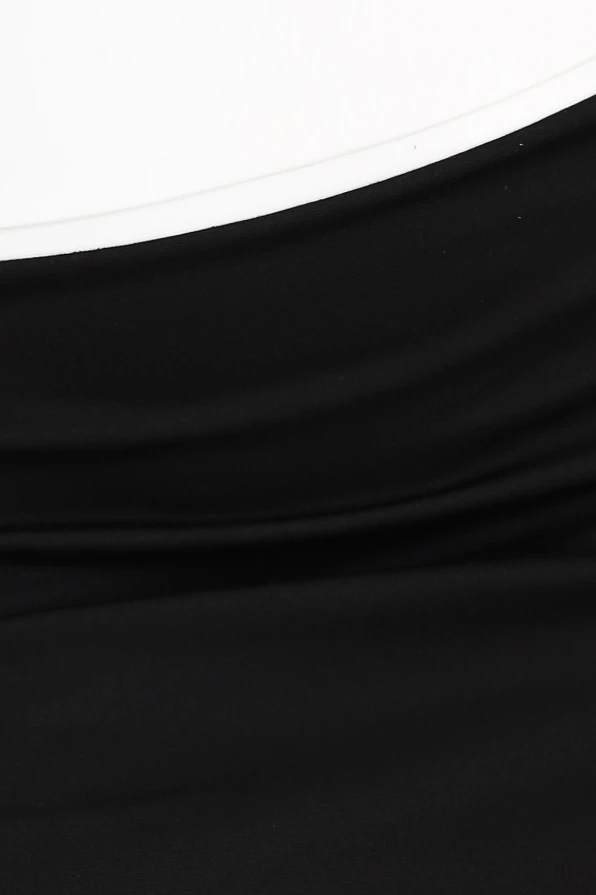 A close-up of a two-tone skirt featuring a smooth black fabric with a subtle, elegant drape. The material appears soft and stretchy, offering a comfortable and stylish fit.